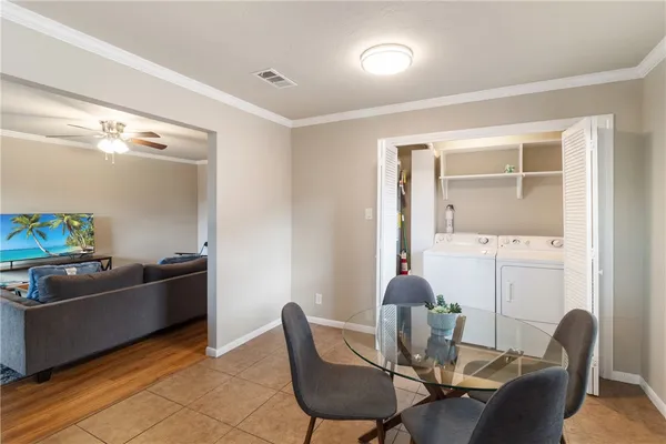 a dining room with furniture and wooden floor