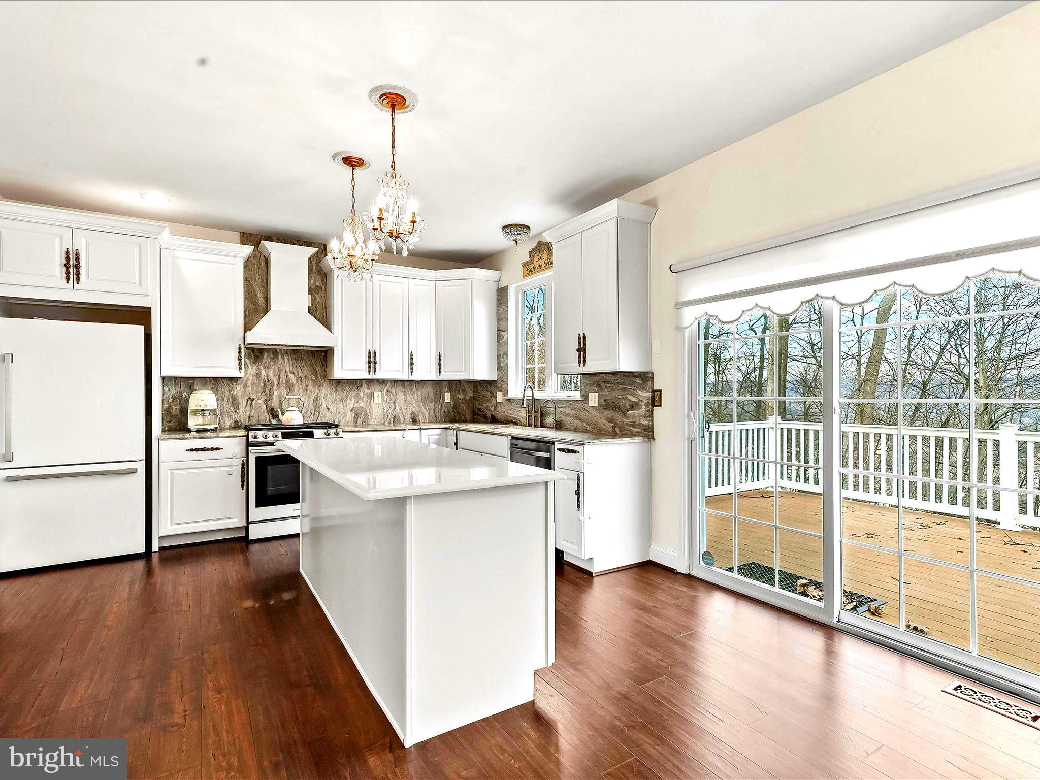 3033 Honeymead Road Downingtown, PA 19335 - Photo 13 of 47 a kitchen with white cabinets and white appliances