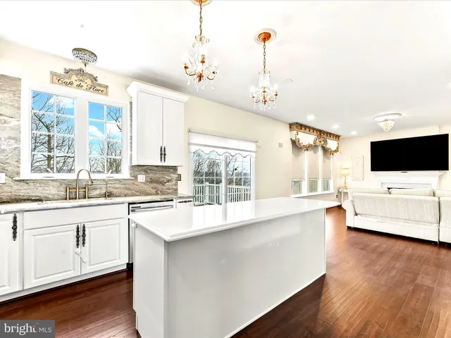 a large white kitchen with a large window