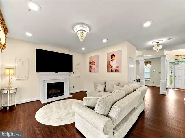 a living room with furniture flat screen tv and fireplace