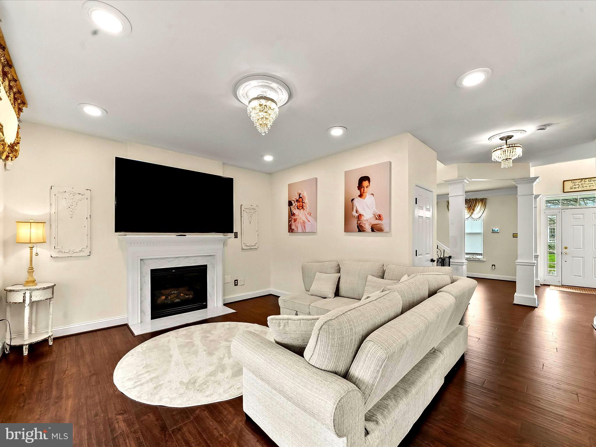 3033 Honeymead Road Downingtown, PA 19335 - Photo 18 of 47 a living room with furniture flat screen tv and fireplace