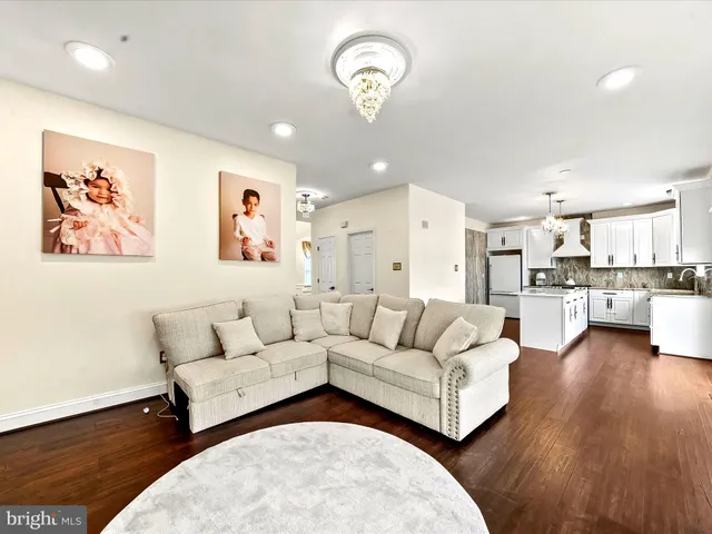 a living room with furniture and kitchen view