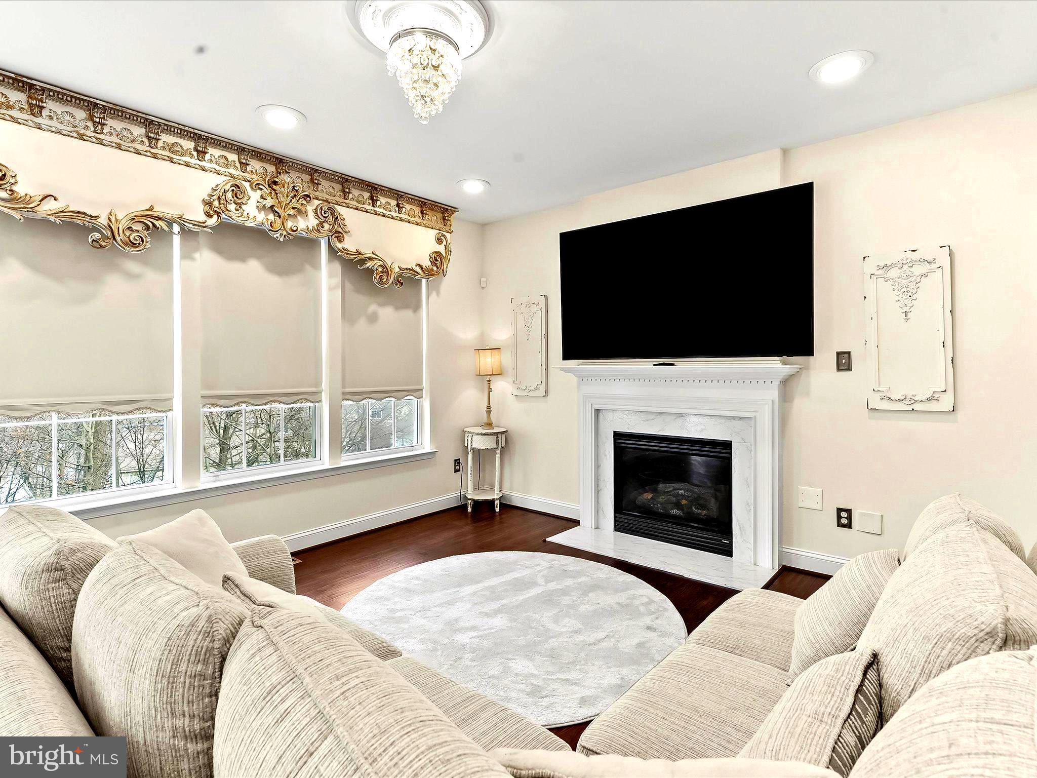 3033 Honeymead Road Downingtown, PA 19335 - Photo 21 of 47 a living room with furniture a fireplace and a flat screen tv