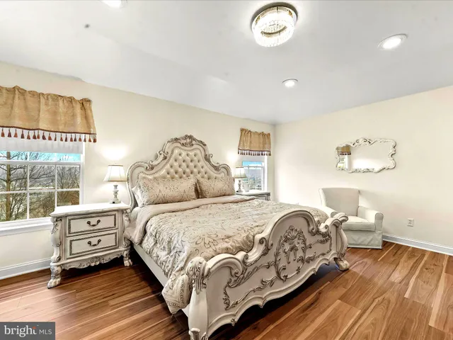 a bedroom with a bed and a large window