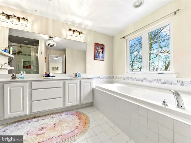 a bathroom with a bathtub sink and a window