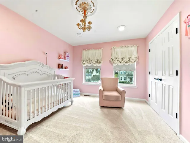 a bedroom with furniture and a large window