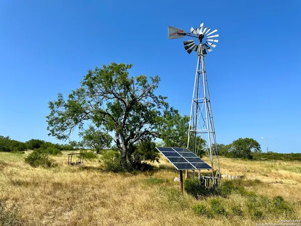 a view of a swimming pool with a house in the background
