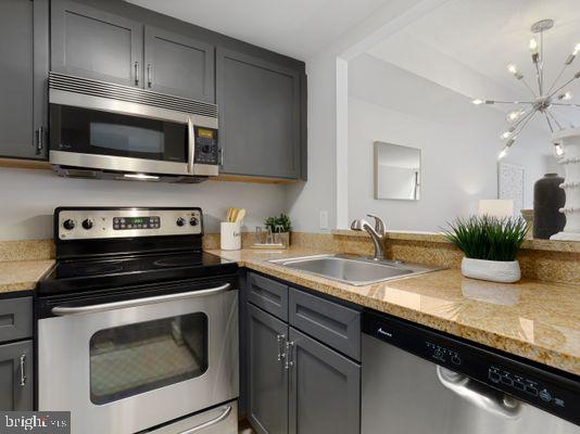 1150 K Street Northwest, Unit 709 Washington, DC 20005 - Photo 13 of 25 a kitchen with a sink stove and microwave