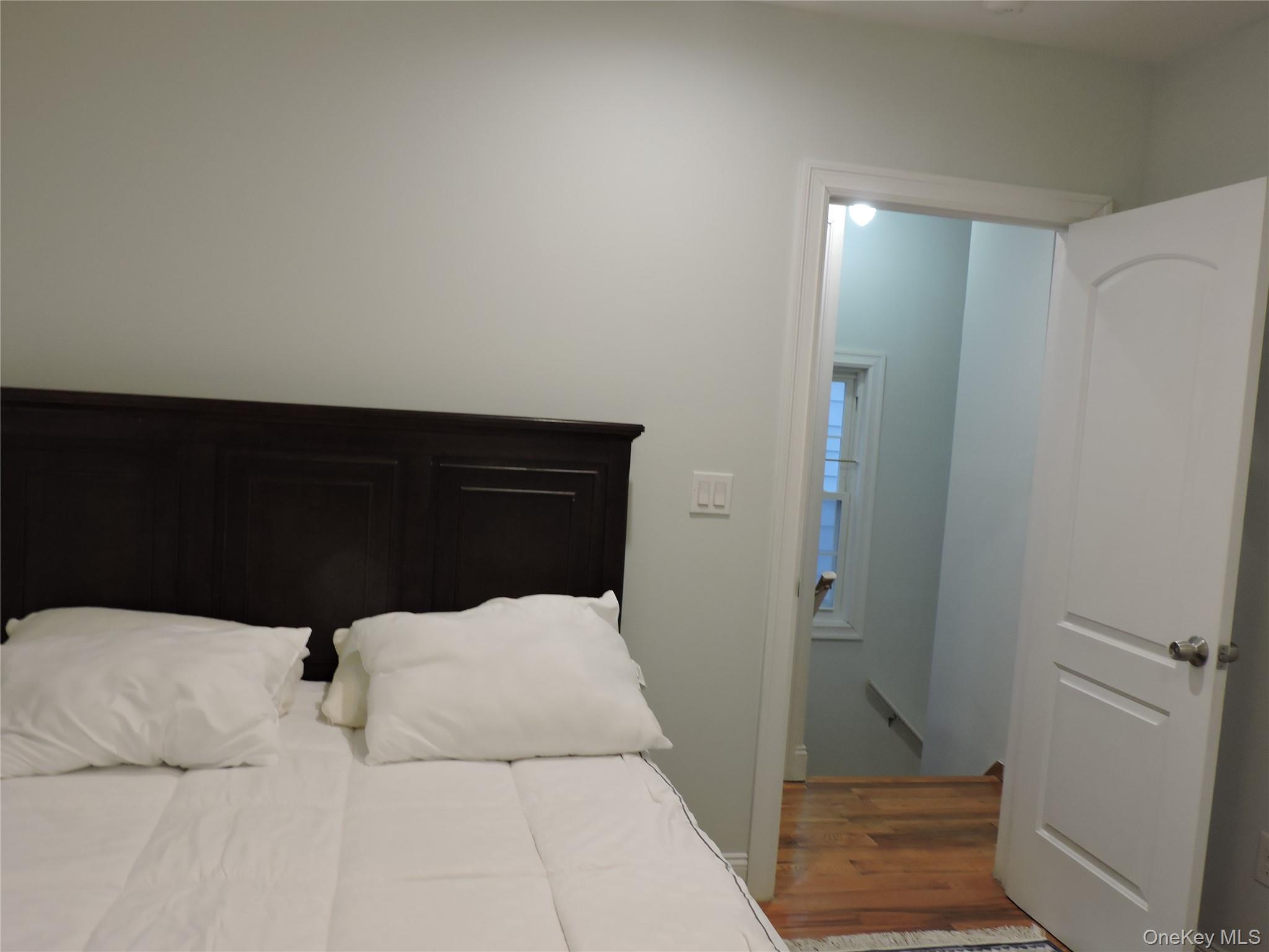 194-00 112th Road Queens, NY 11412 - Photo 12 of 17 a bedroom with a bed and wooden floor