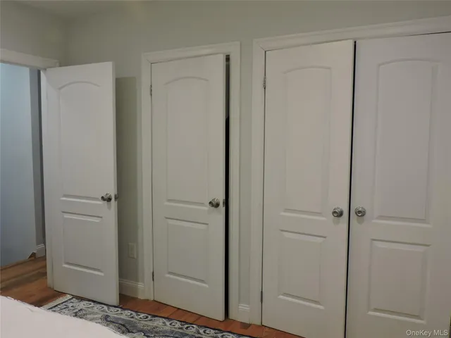a bedroom with a bed and cabinets