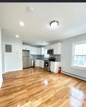 a view of a kitchen with a sink and cabinets
