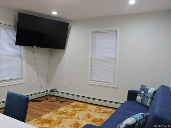 a living room with a flat screen tv and a window