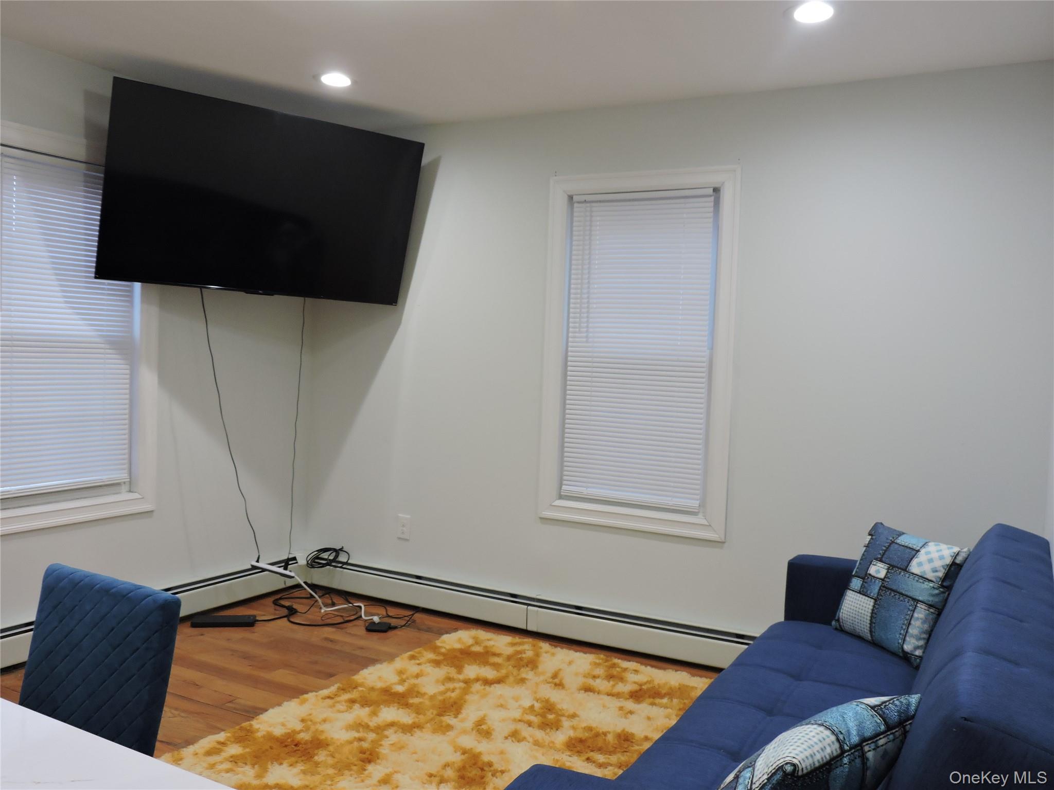 194-00 112th Road Queens, NY 11412 - Photo 4 of 17 a living room with a flat screen tv and a window