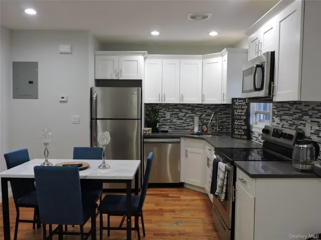 a kitchen with a sink cabinets and stainless steel appliances