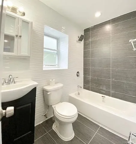 a bathroom with a sink toilet a mirror and shower