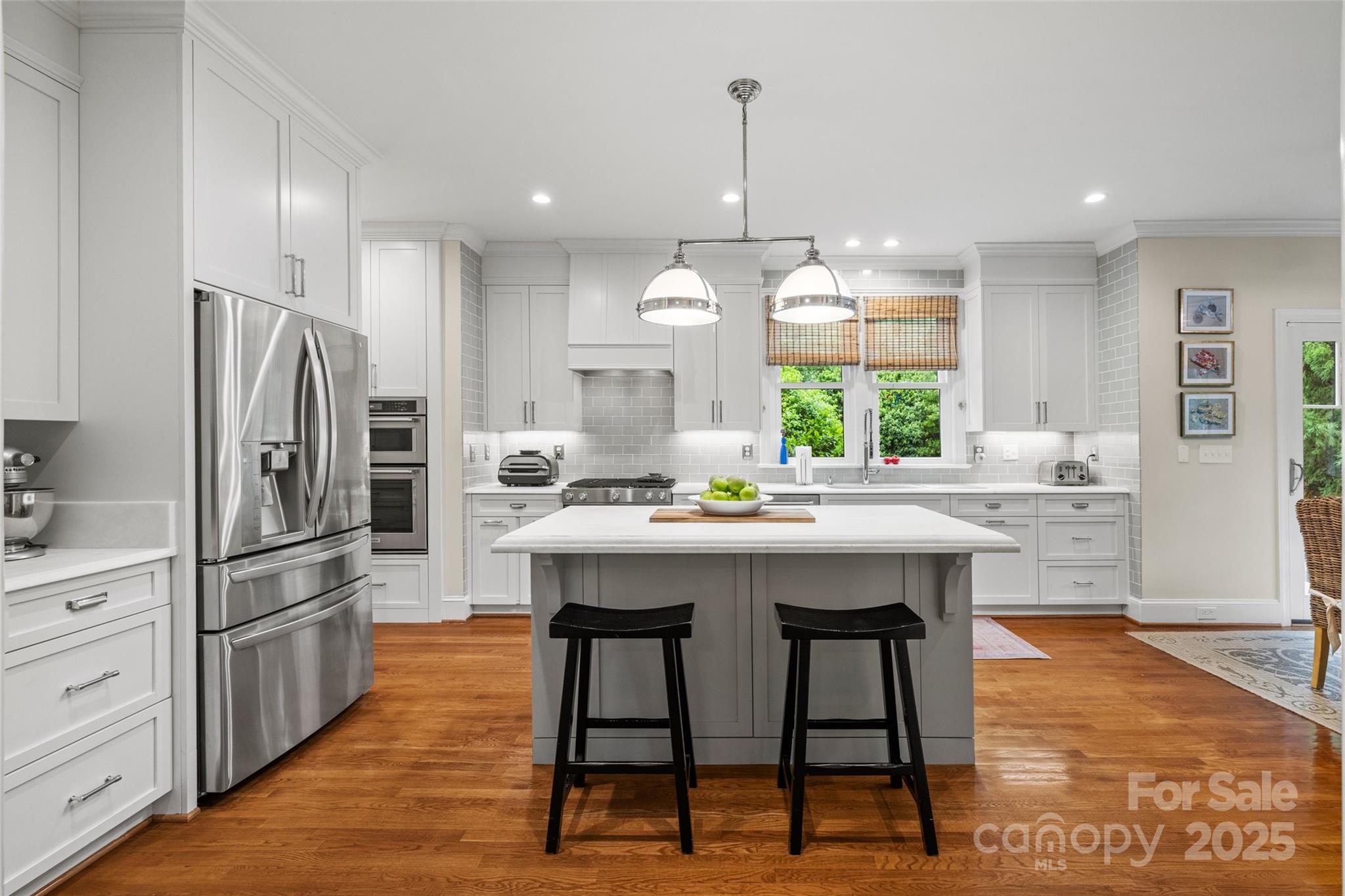 2329 Club Road Charlotte, NC 28205 - Photo 14 of 48 a kitchen with stainless steel appliances a dining table chairs stove refrigerator and cabinets
