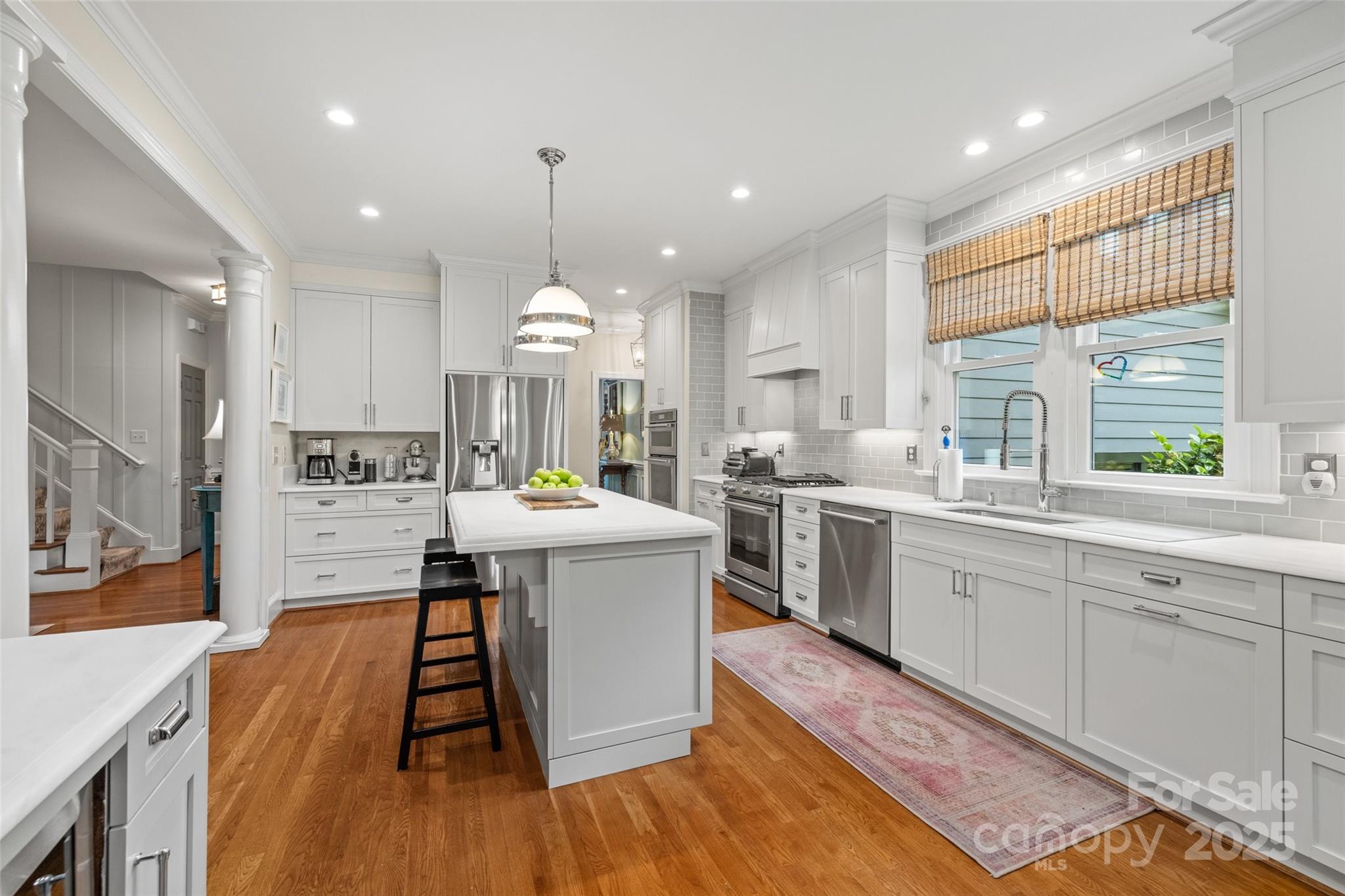 2329 Club Road Charlotte, NC 28205 - Photo 17 of 48 a kitchen with stainless steel appliances granite countertop a sink a stove a refrigerator and a dining table with wooden floor