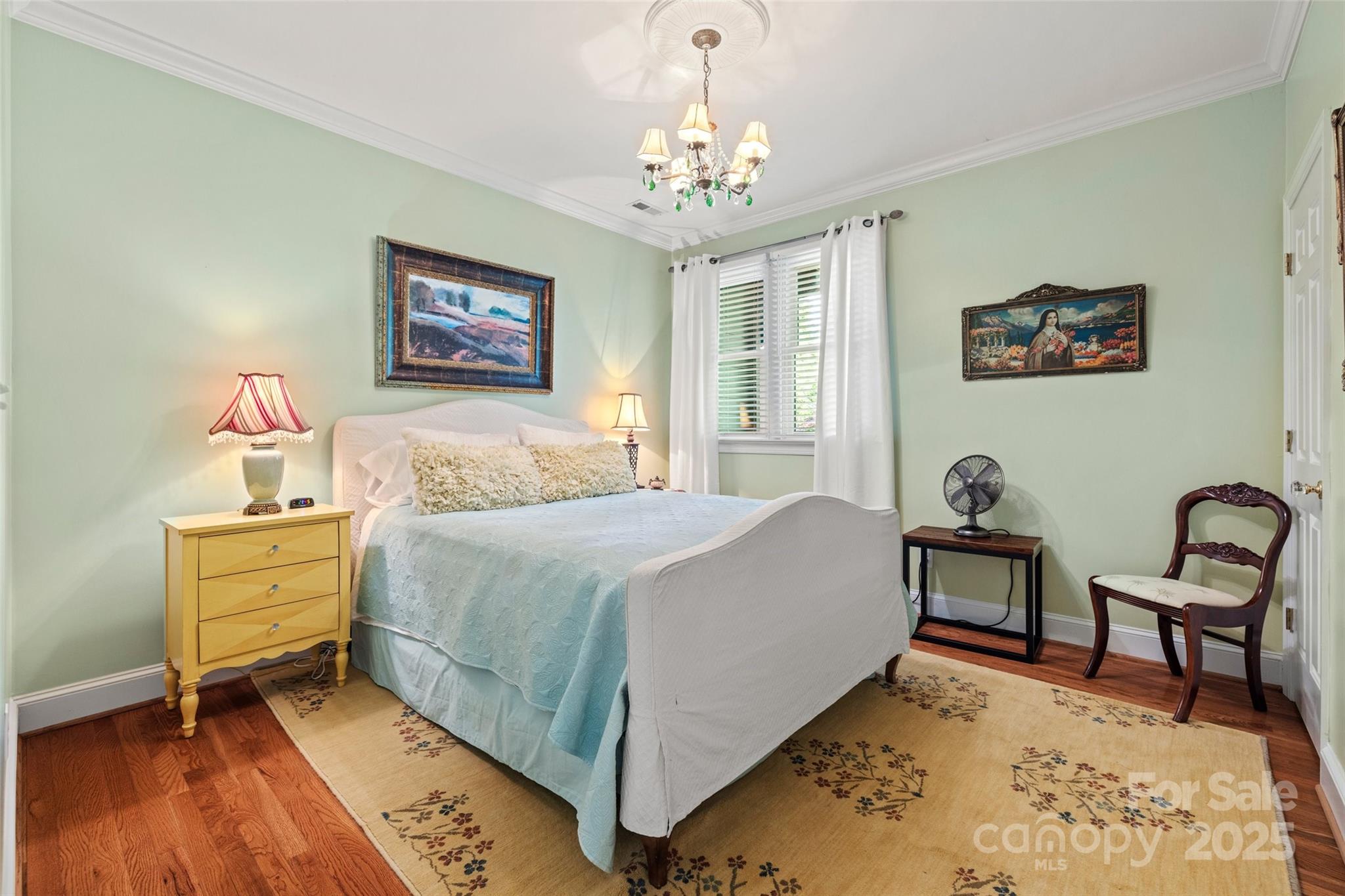 2329 Club Road Charlotte, NC 28205 - Photo 33 of 48 a bedroom with a bed and a chandelier