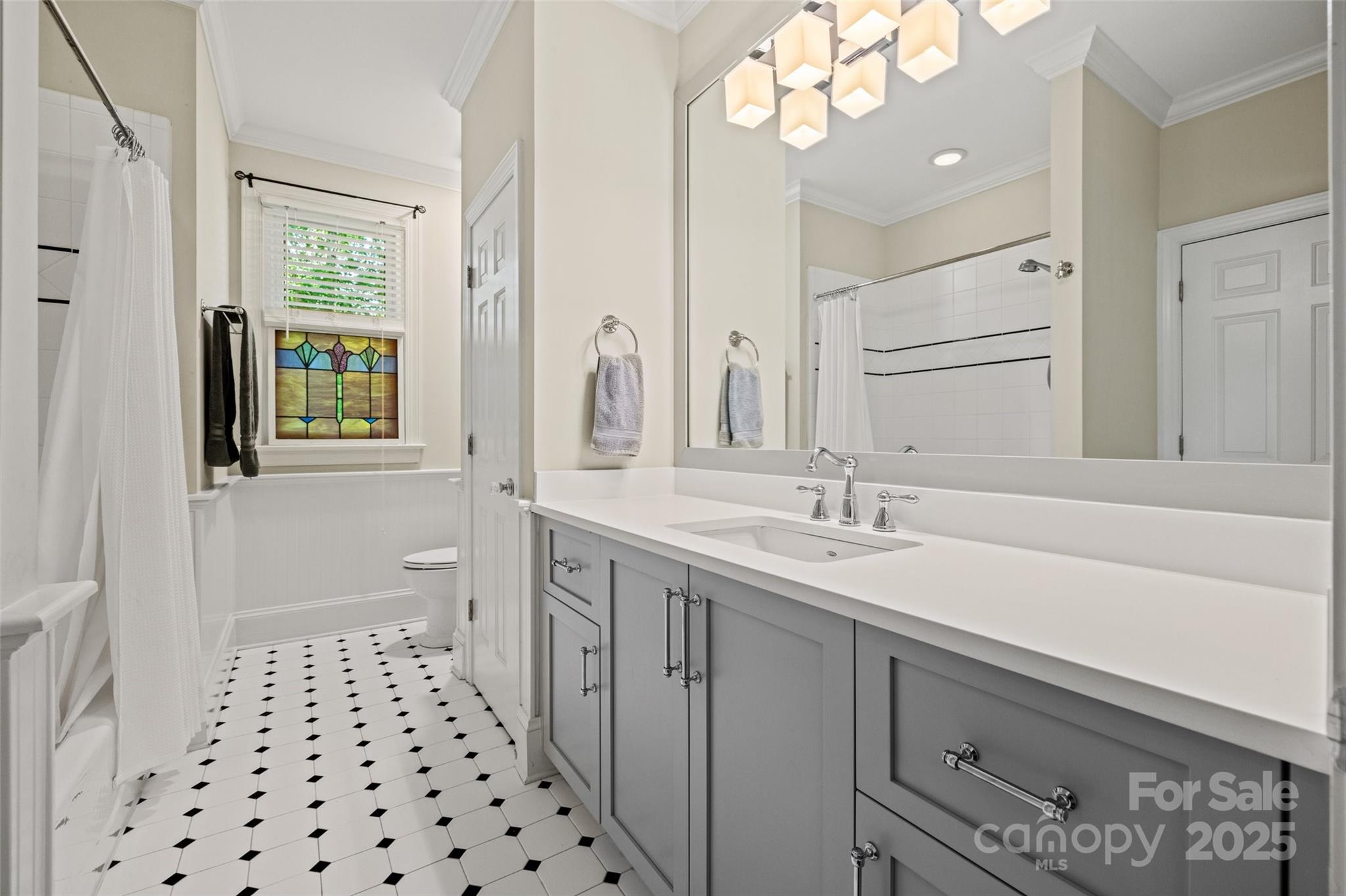 2329 Club Road Charlotte, NC 28205 - Photo 34 of 48 a bathroom with a sink a mirror and a shower