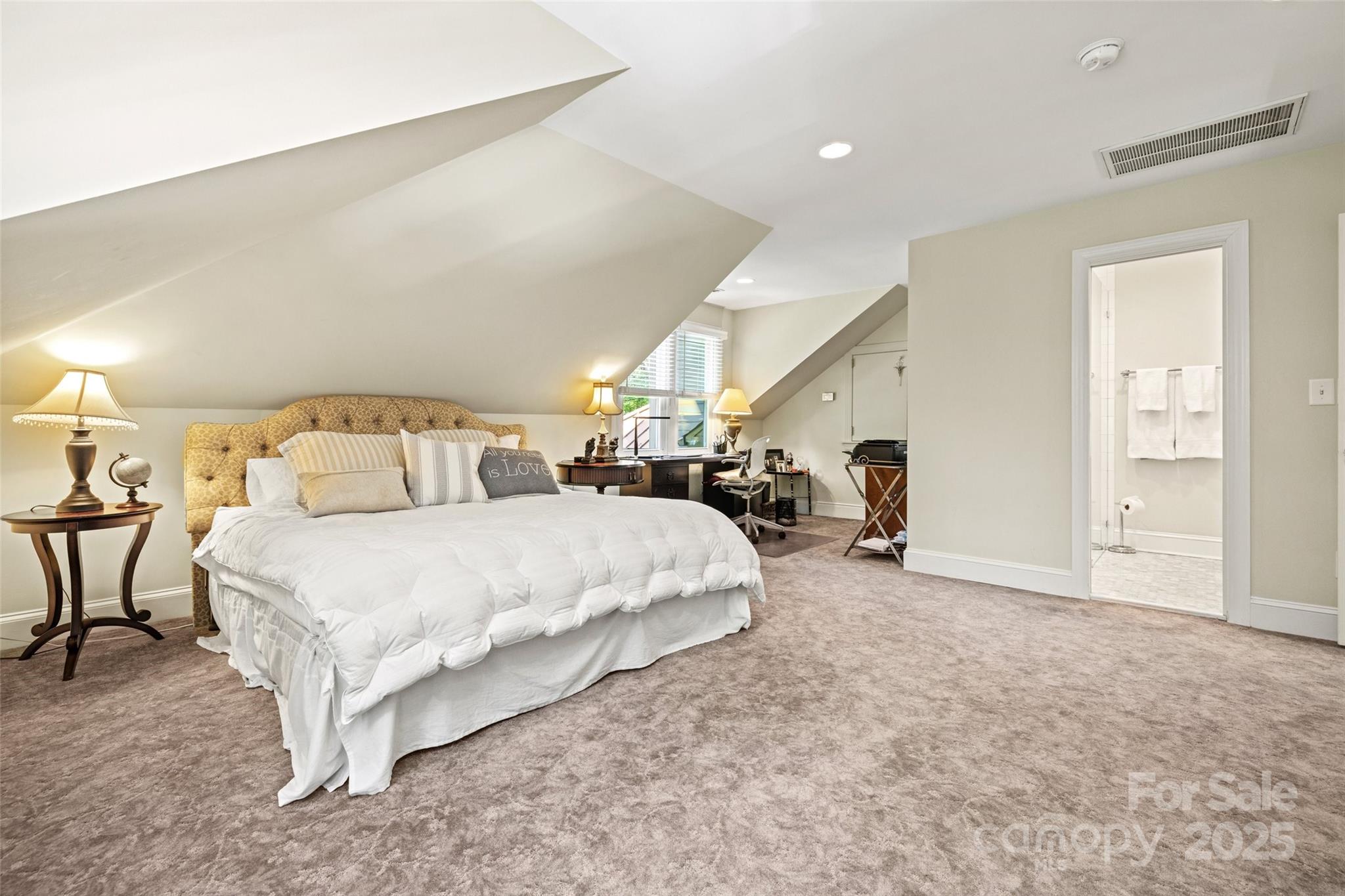 2329 Club Road Charlotte, NC 28205 - Photo 38 of 48 a spacious bedroom with a bed a table and chair