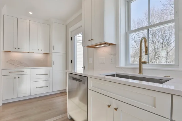 a kitchen with appliances cabinets and a sink