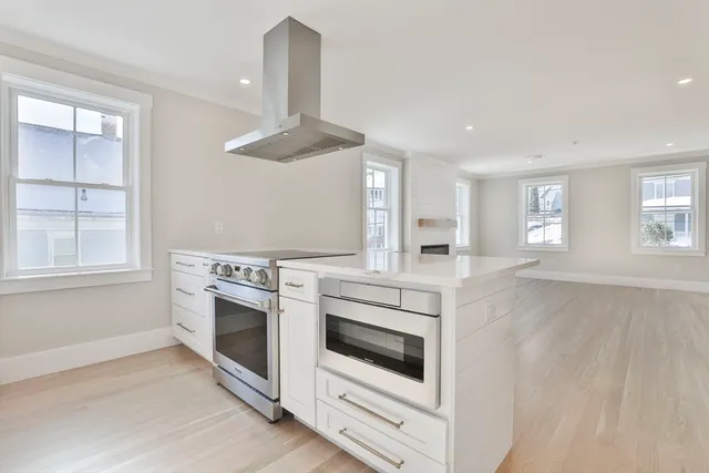 a kitchen with a stove oven and window