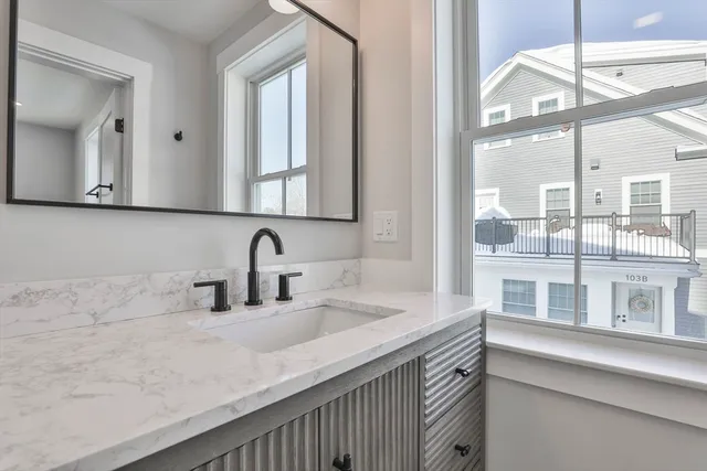 a bathroom with a sink and a large mirror