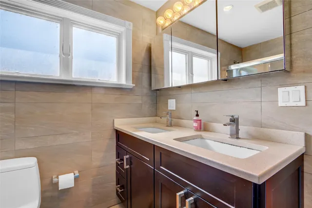 a bathroom with a sink a vanity and a toilet