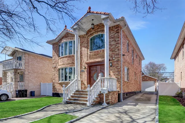a front view of a building with a garden