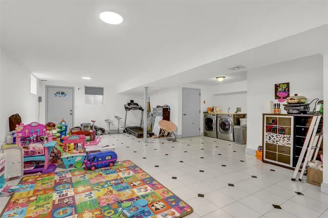 a bedroom with furniture a rug and gym equipment