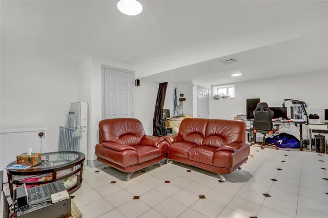 a living room with furniture a air conditioner and a window