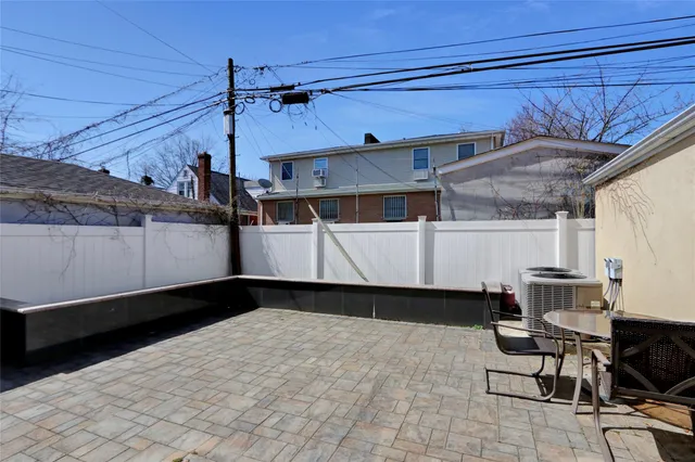 a view of a porch with furniture and floor to ceiling window