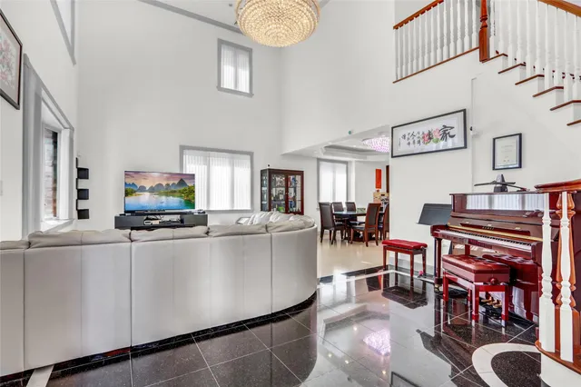 a living room with furniture a flat screen tv and a table