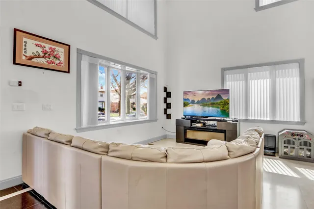 a living room with furniture and flat screen tv