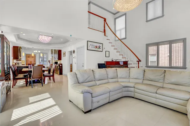 a living room with fireplace furniture and a potted plant