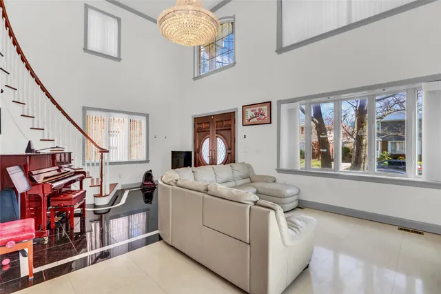 a bedroom with furniture and a large window