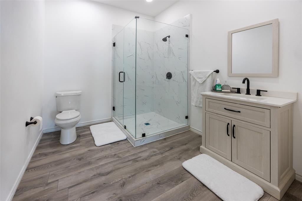 2630 Rockhill Road Aubrey, TX 76227 - Photo 31 of 36 a bathroom with a toilet sink and a shower