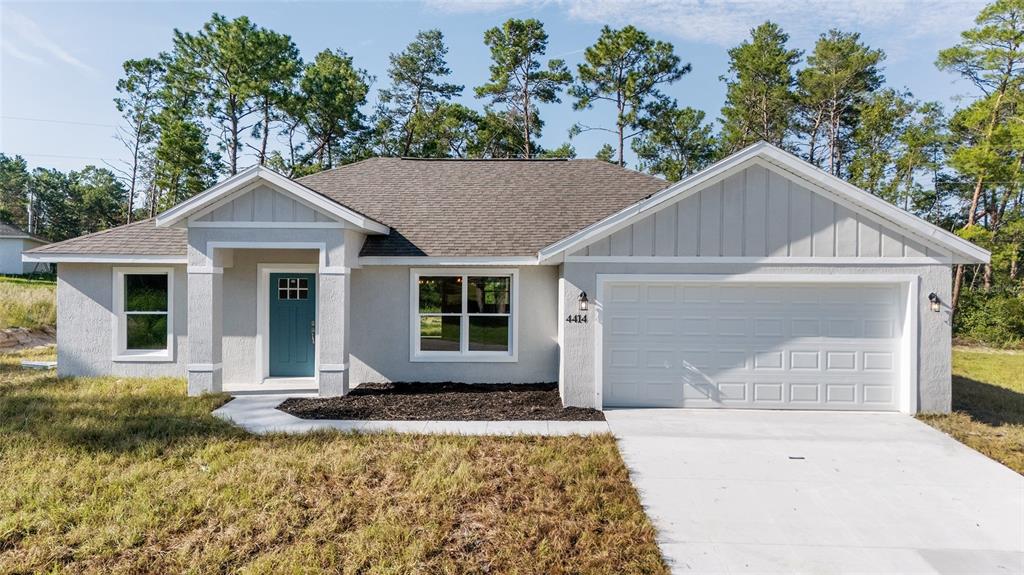 4414 Southwest 172nd Pl Road Ocala, FL 34473 - Photo 1 of 1 a front view of a house with a yard and garage
