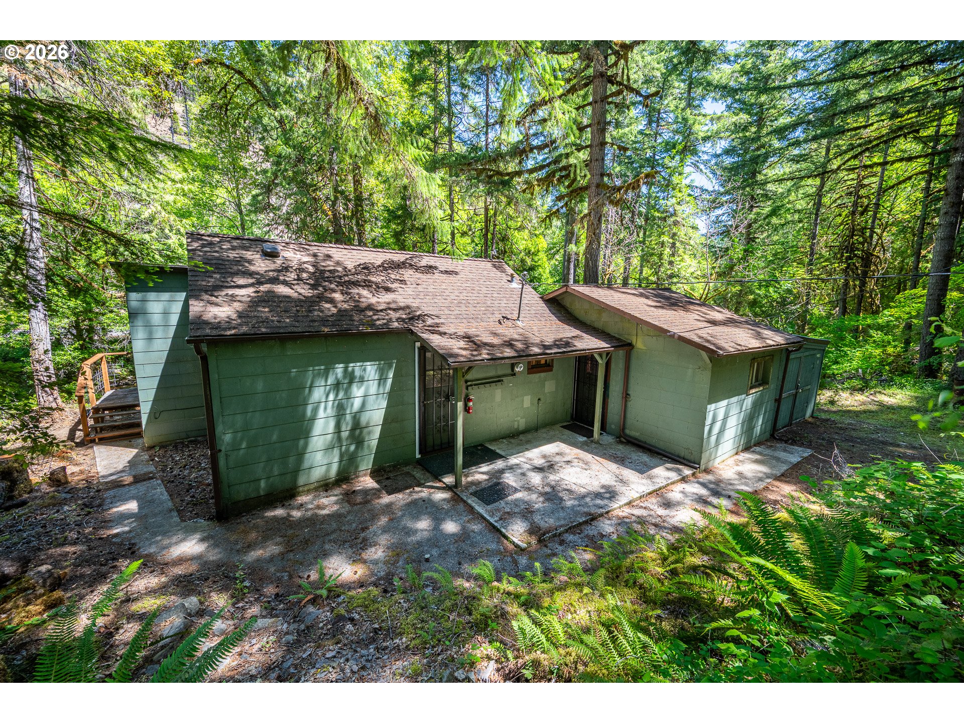 49091 Salt Creek Road Oakridge, OR 97463 - Photo 8 of 16 a backyard of a house with table and chairs