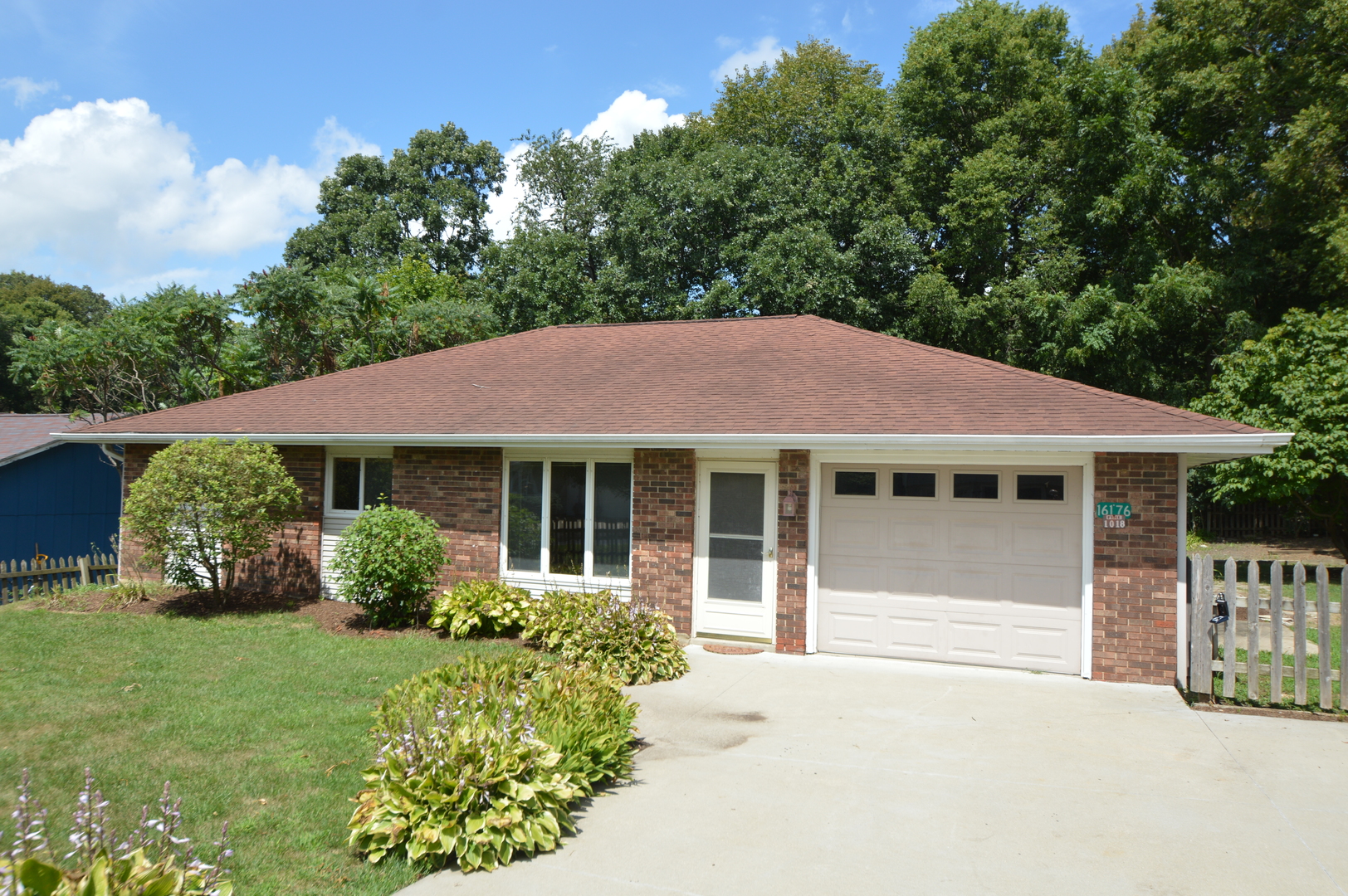 16176 Strawberry Road Morrison, IL 61270 - Photo 1 of 42 a front view of a house with a garden