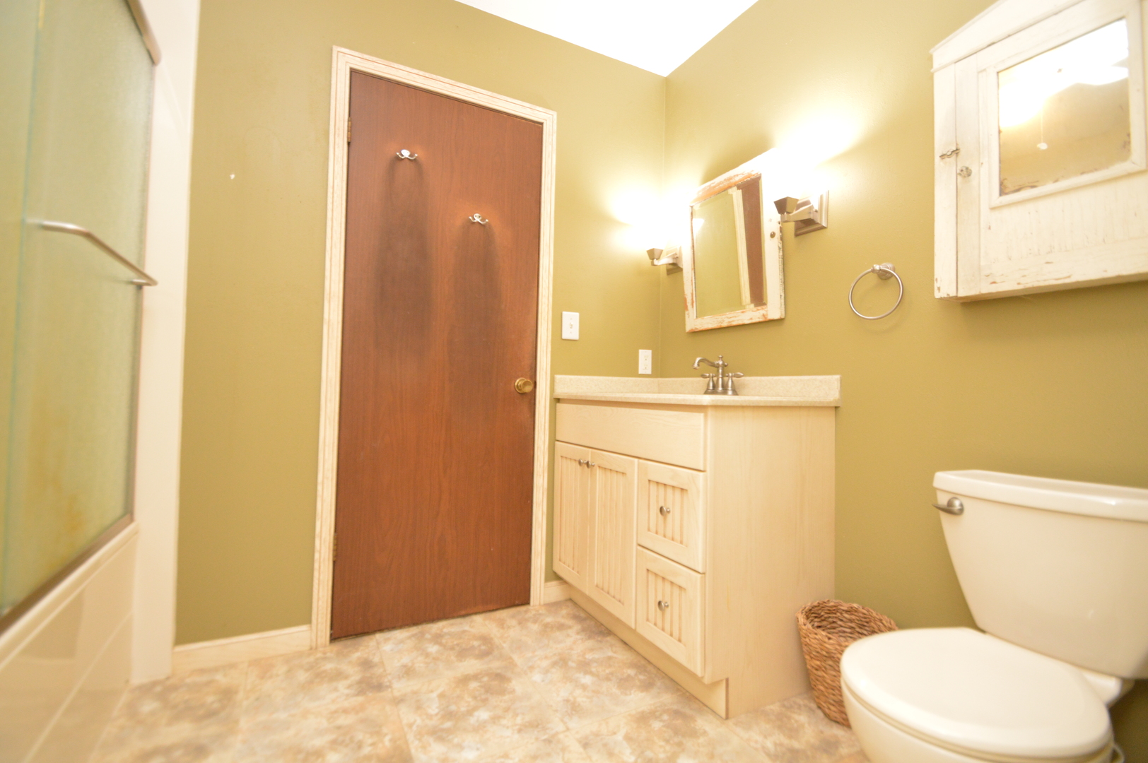 16176 Strawberry Road Morrison, IL 61270 - Photo 20 of 42 a bathroom with a sink a toilet a mirror and vanity