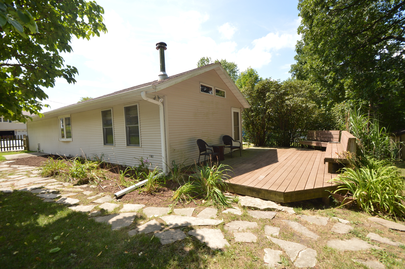 16176 Strawberry Road Morrison, IL 61270 - Photo 32 of 42 a backyard of a house with table and chairs and wooden fence