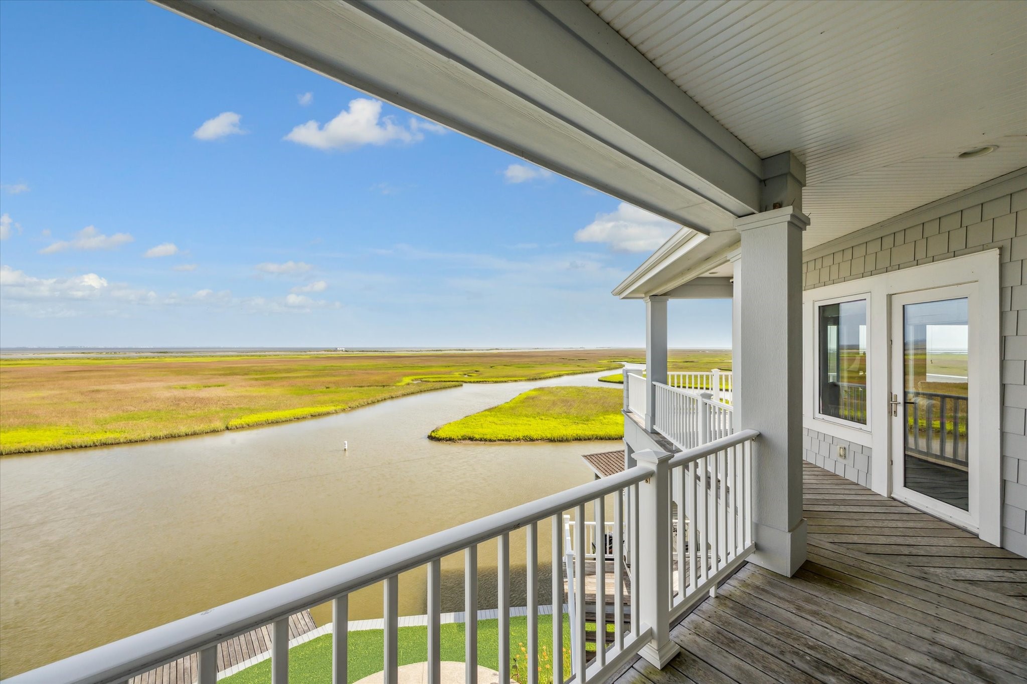 1 Shell Key Hitchcock, TX 77563 - Photo 37 of 50 The top-level covered balcony offers panoramic, elevated views of the surrounding wetlands and West Galveston Bay