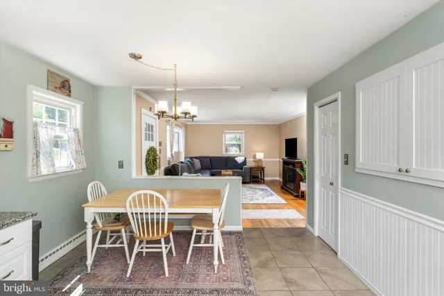 a view of a dining room with furniture and chandelier