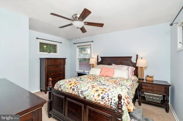a bedroom with a bed and a ceiling fan