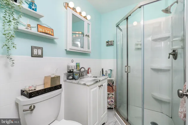 a bathroom with a sink a toilet and shower