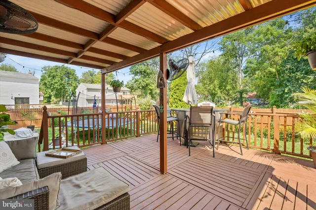 a view of a balcony with chairs and wooden floor