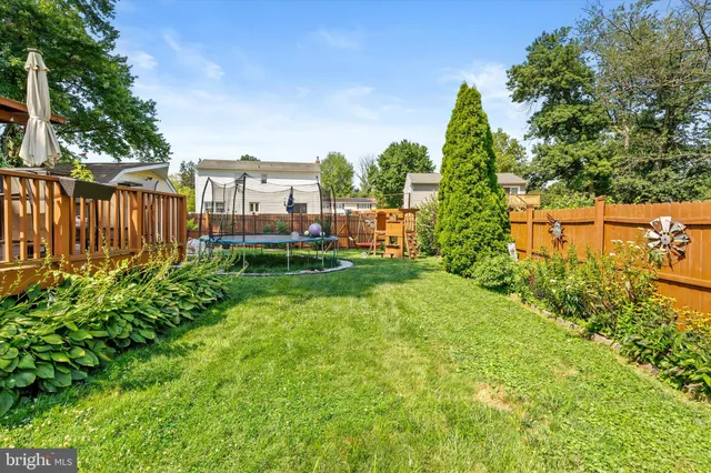 a view of a garden with a building in the background