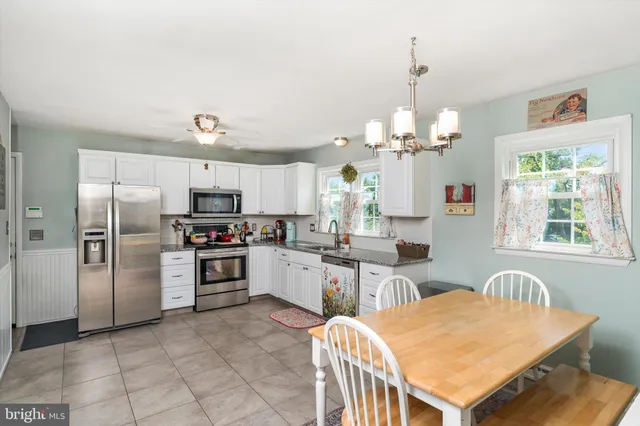 a kitchen with refrigerator cabinets and windows