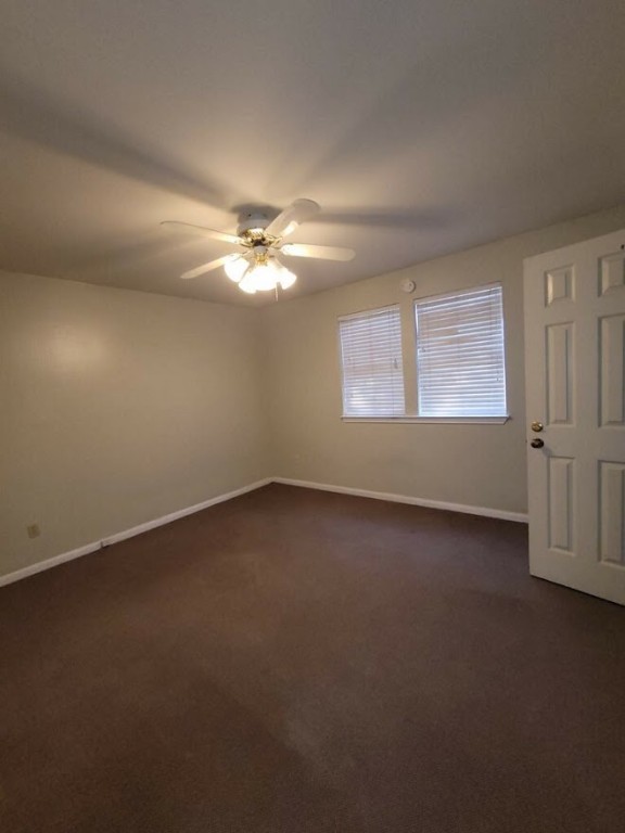 2529 Rio Grande Street, Unit 20 Austin, TX 78705 - Photo 15 of 19 an empty room with a chandelier fan and windows